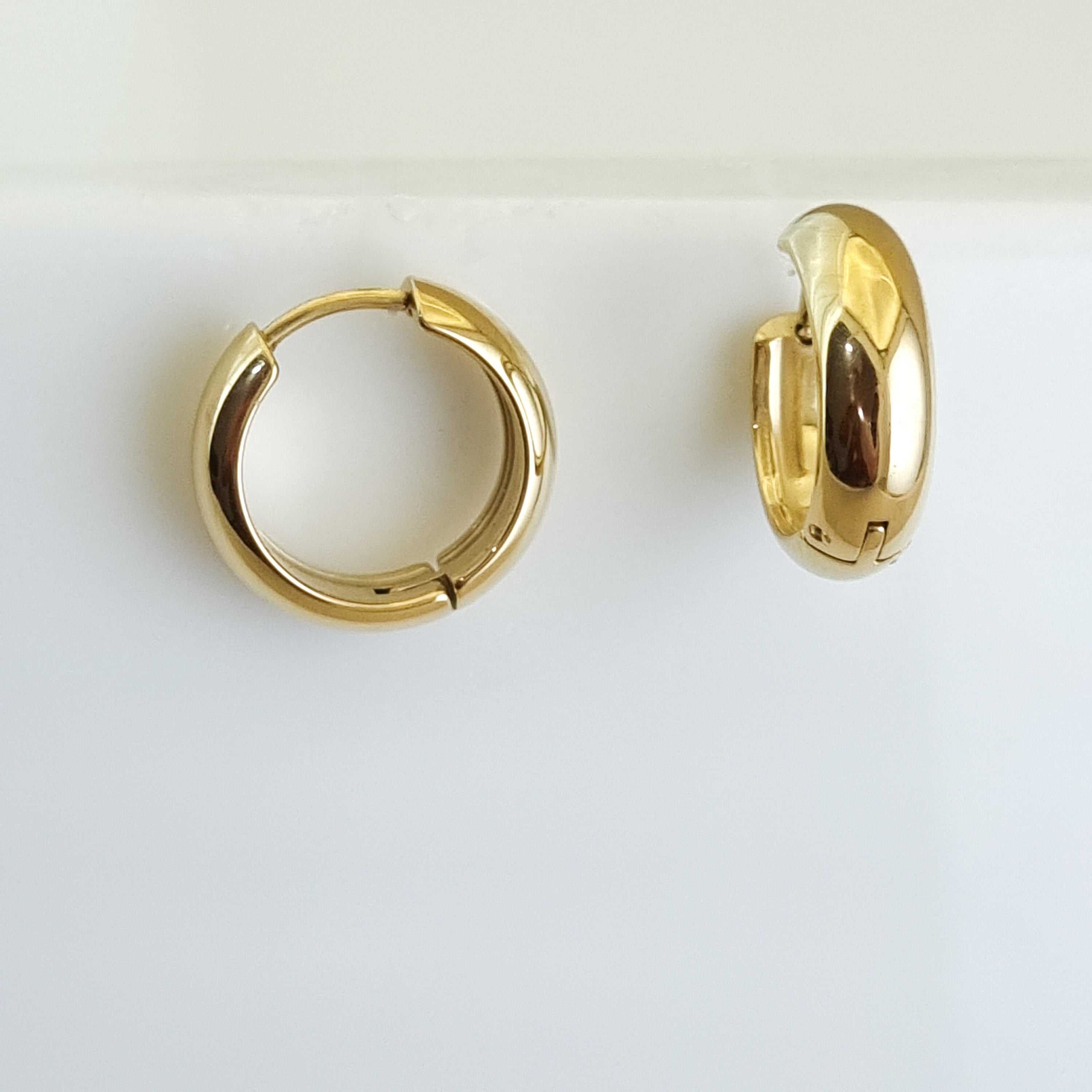 18K gold-plated tubular hoops, waterproof gold earrings, anti-tarnish statement hoops, hypoallergenic luxury jewelry, sculptural gold earrings, thick medium hoop earrings.