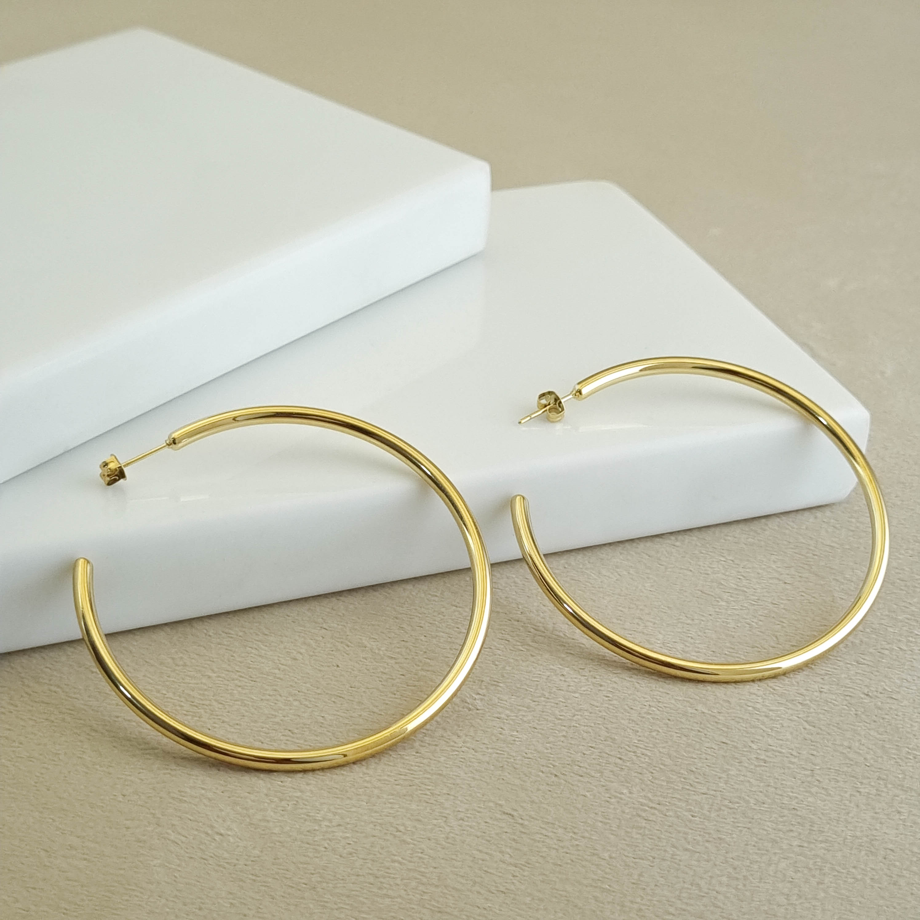 18K gold-plated large hoops, waterproof gold earrings, anti-tarnish statement hoops, hypoallergenic luxury jewelry, sculptural gold earrings, oversized tubular hoop earrings.