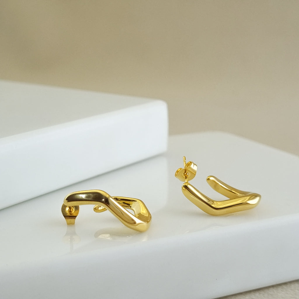 18K gold-plated geometric huggies, waterproof gold earrings, anti-tarnish sculptural hoops, hypoallergenic luxury jewelry, liquid metal earrings, unique gold huggies.