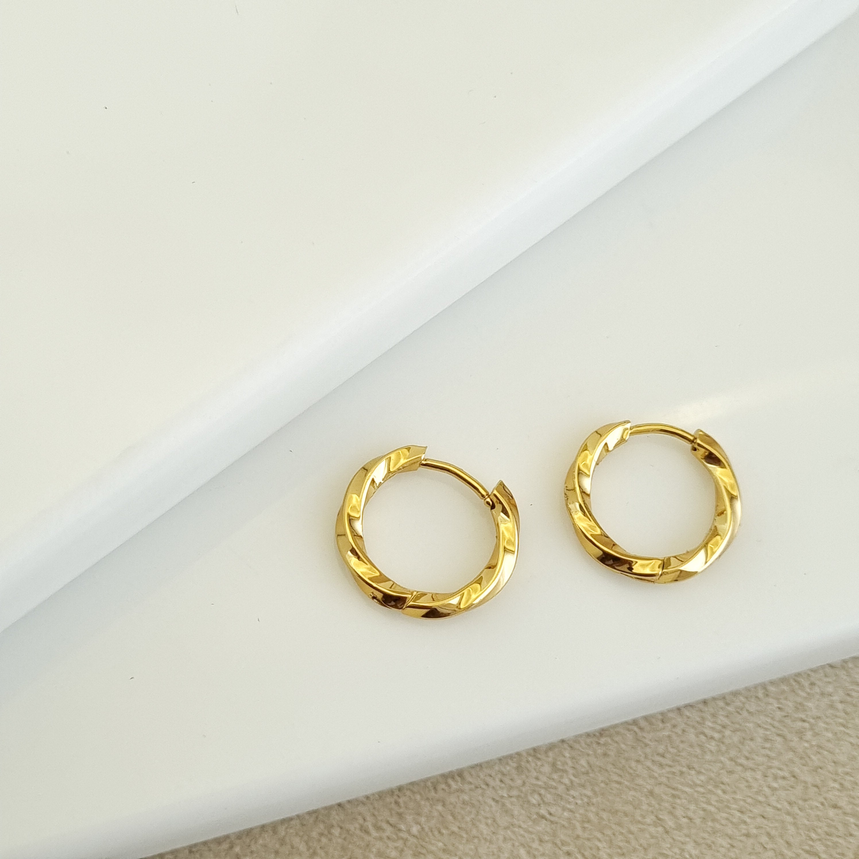 18K gold-plated twist hoops, waterproof gold earrings, anti-tarnish spiral huggies, hypoallergenic luxury jewelry, sculptural gold hoops, helix twist earrings.