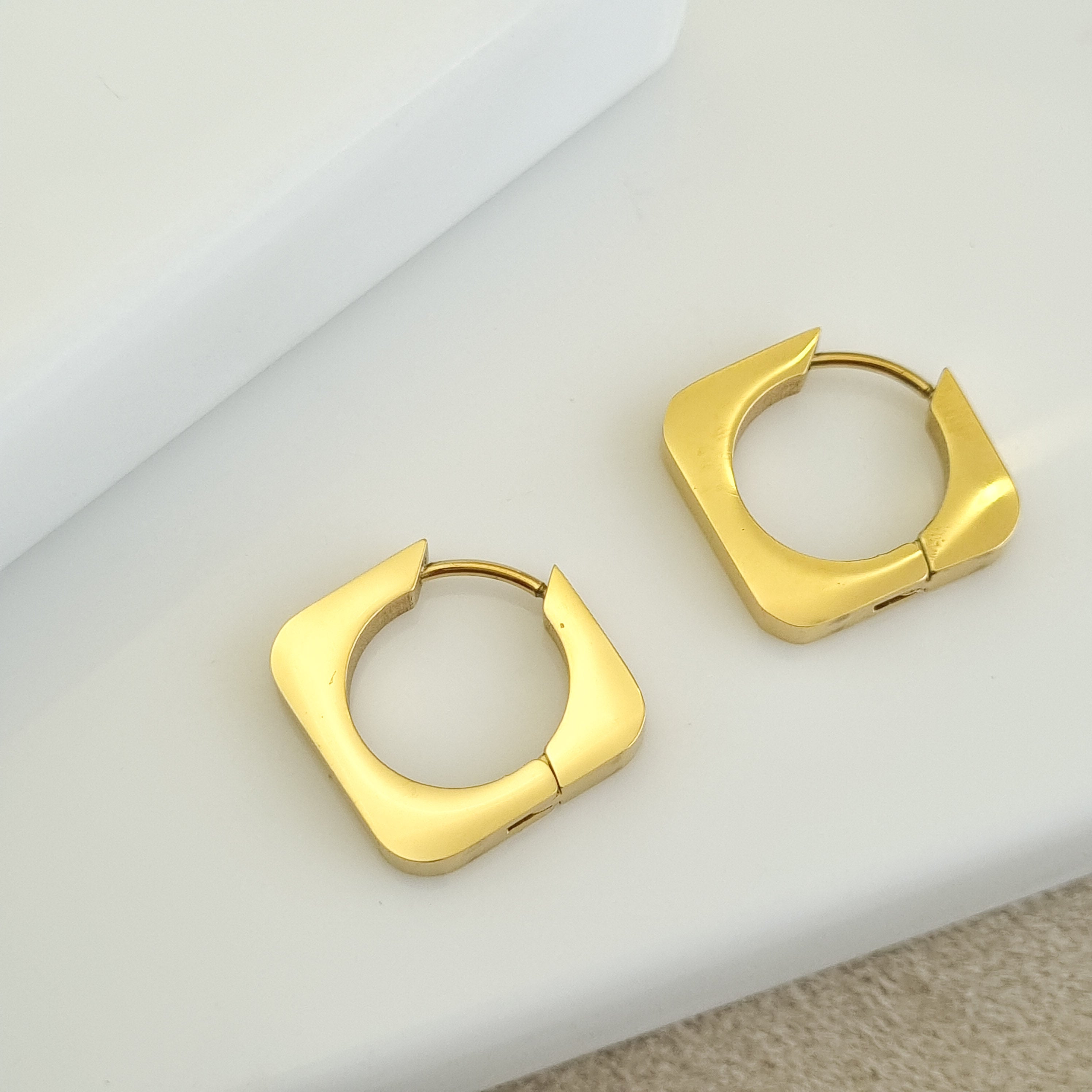 18K gold-plated rectangular hoops, waterproof gold earrings, anti-tarnish geometric huggies, hypoallergenic luxury jewelry, sculptural gold earrings, square hoop earrings.