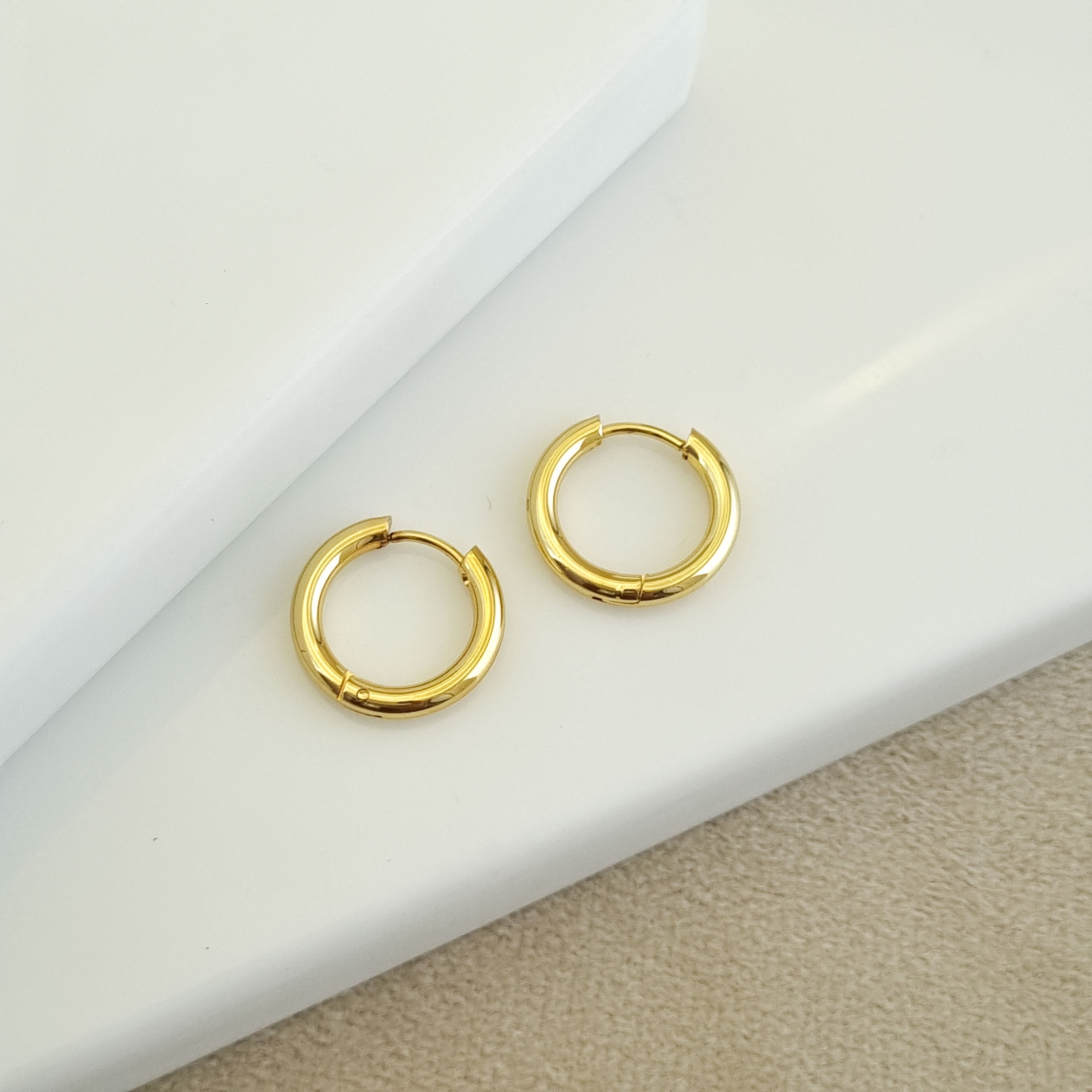 18K gold-plated micro hoops, waterproof gold earrings, anti-tarnish petite hoops, hypoallergenic luxury jewelry, sculptural gold huggies, thick small hoop earrings.