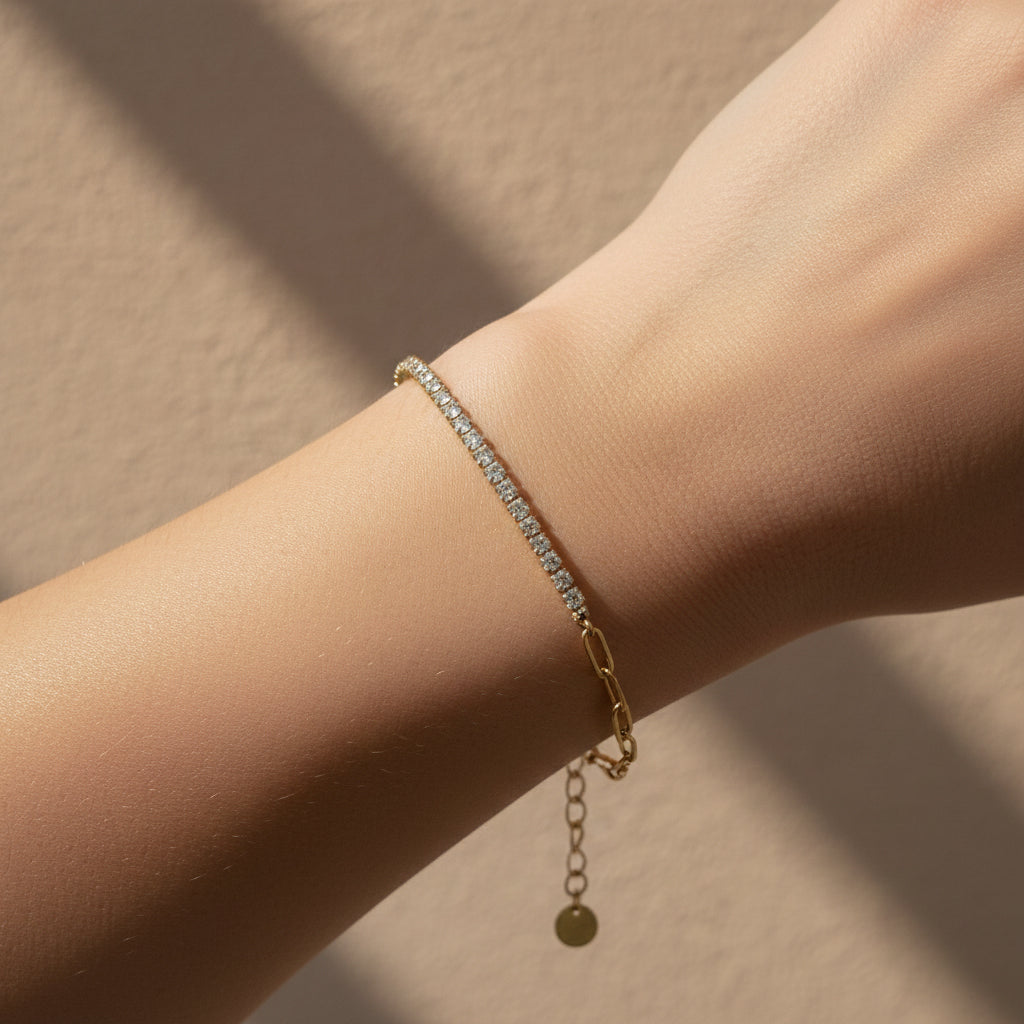 18K gold plated hybrid bracelet featuring one half paperclip chain links and one half clear crystal tennis chain on a white background.