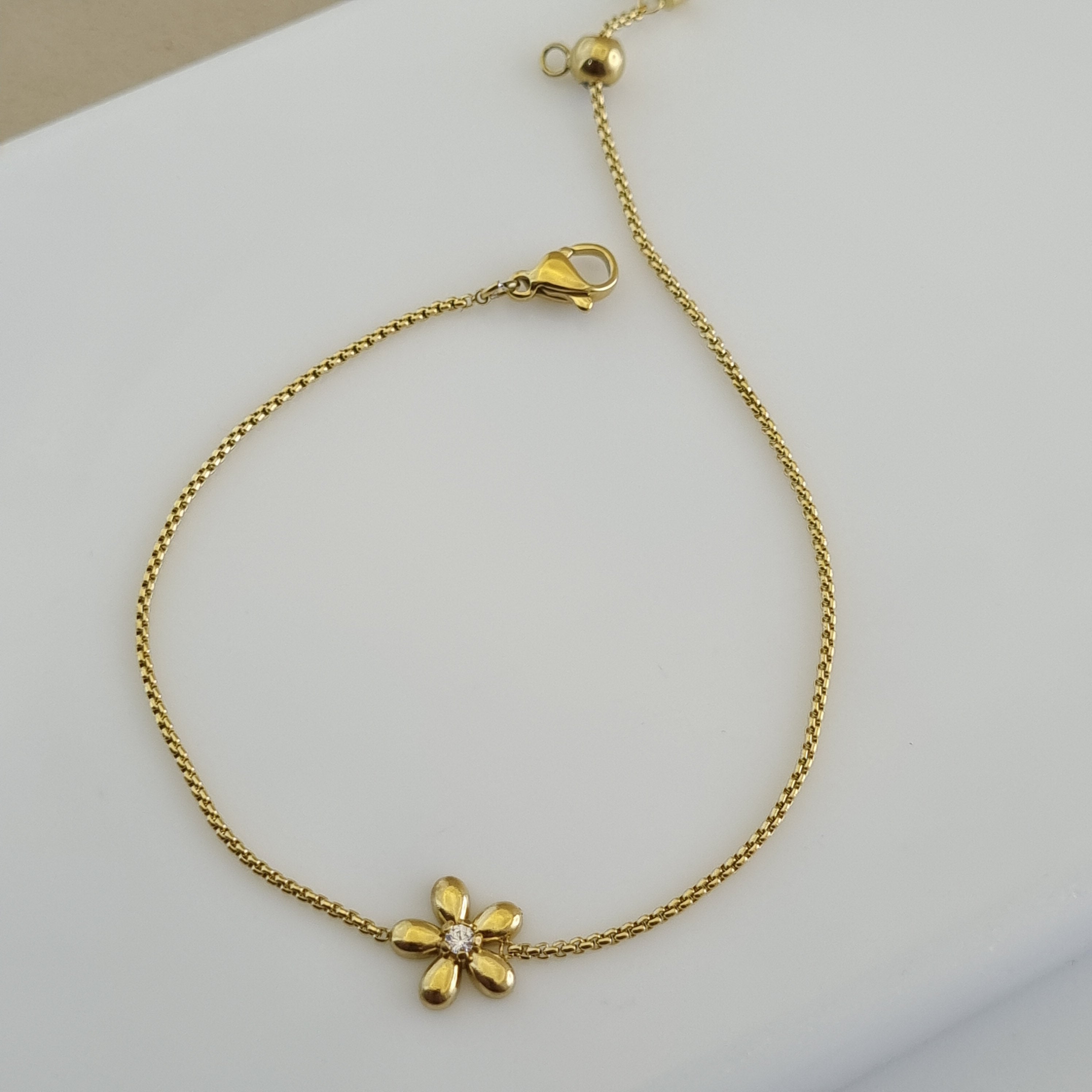 Gold flower jewelry for women, minimalist crystal bracelet, durable gold plated accessories, hypoallergenic gold bracelet, dainty gold gift.