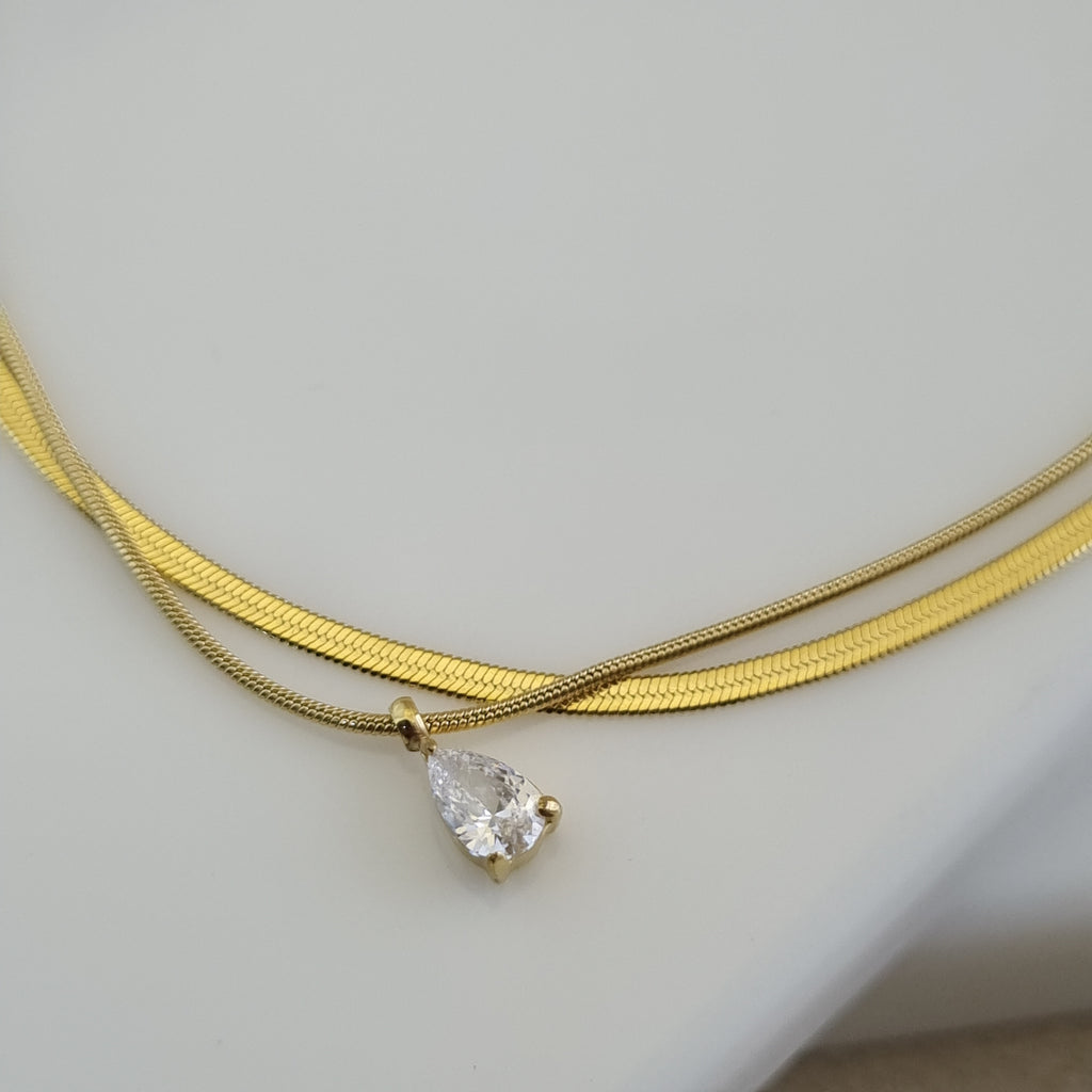 18K gold plated double-layer anklet with a flat herringbone chain and a pear-cut zirconia crystal charm.