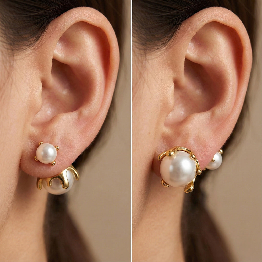 Close up of a woman's ear wearing 18K gold-plated pearl jacket earrings with a small pearl in front and a larger pearl in a molten gold setting behind the lobe.