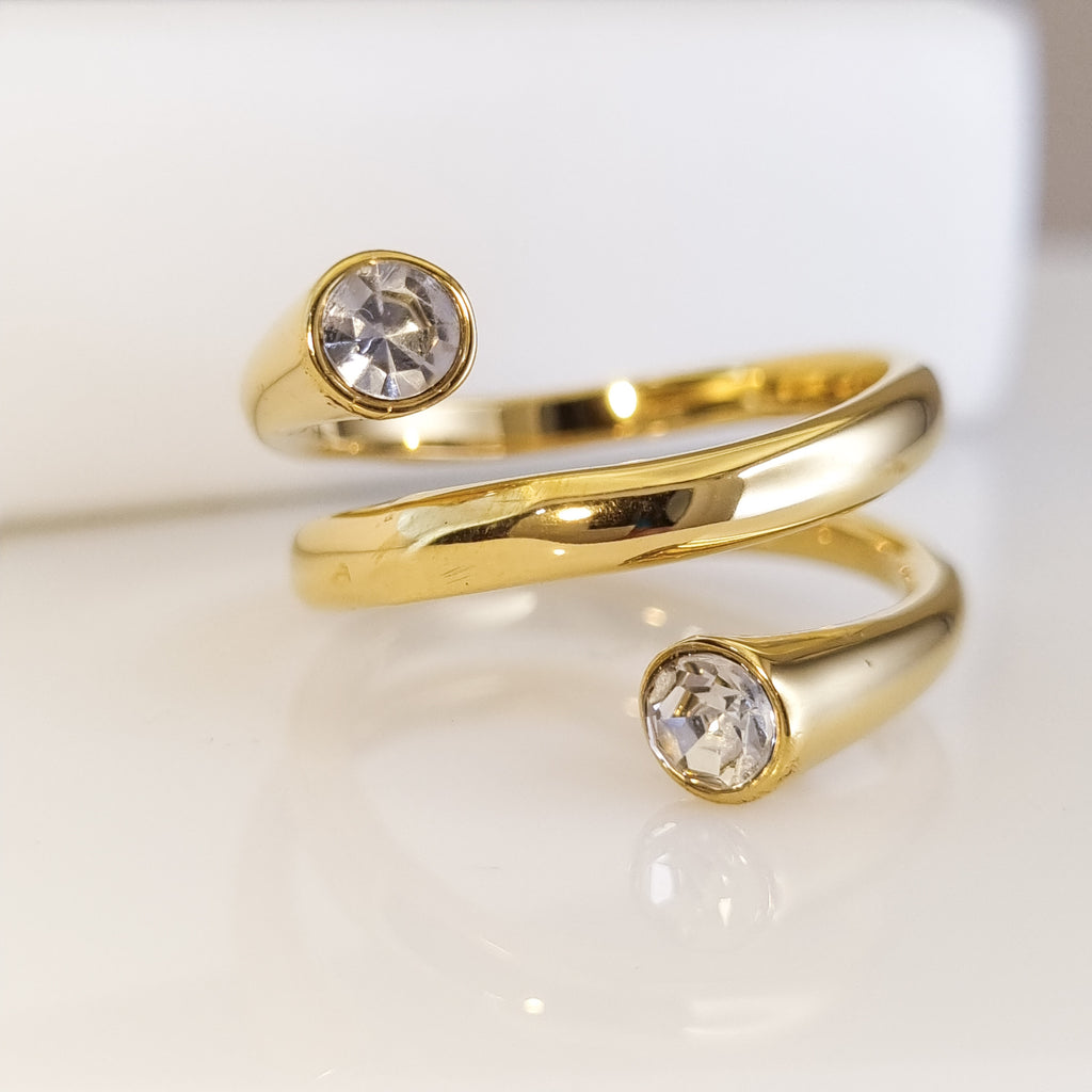 Gold open toe ring with crystal stones on a white background