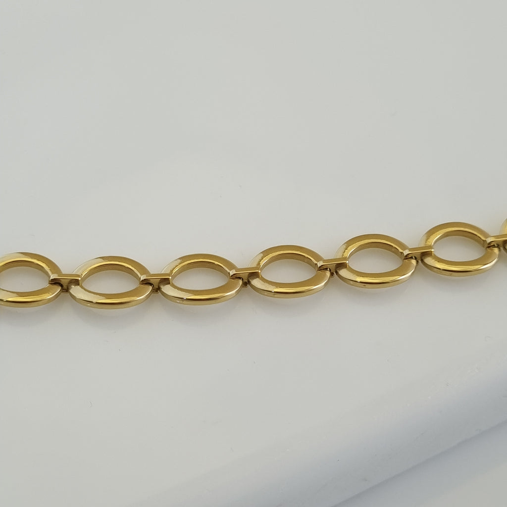 Treshire 18K gold plated Everyday Golden Halo bracelet with polished circular links displayed on a white marble surface.