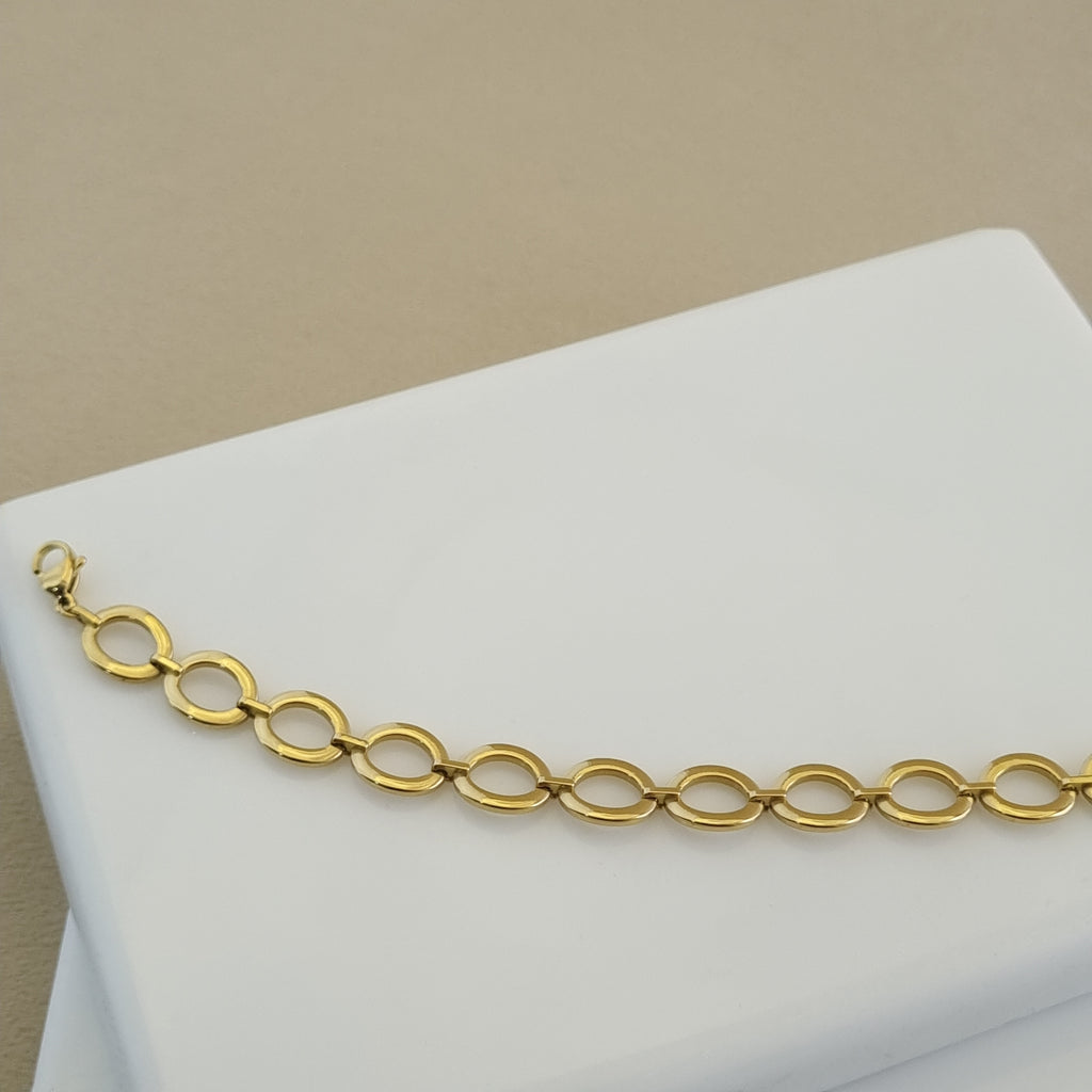 Treshire 18K gold plated Everyday Golden Halo bracelet with polished circular links displayed on a white marble surface.
