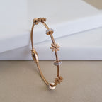 Rose gold daisy bracelet, waterproof cable jewelry, 18K rose gold plated floral bangle, anti-tarnish charm bracelet, nature-inspired rose gold jewelry.