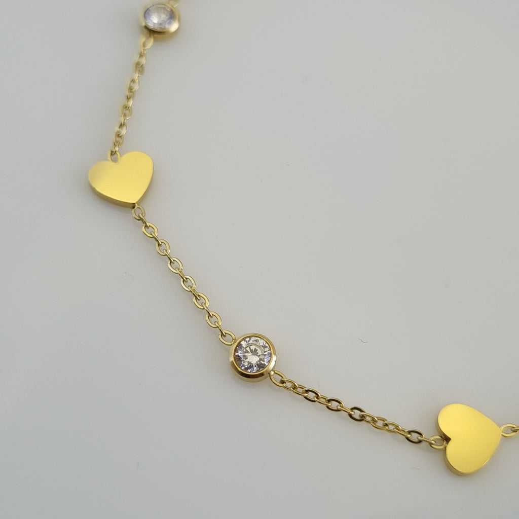 Treshire 18K gold plated Whimsical Heart bracelet with alternating heart charms and bezel-set crystals on a fine gold chain.