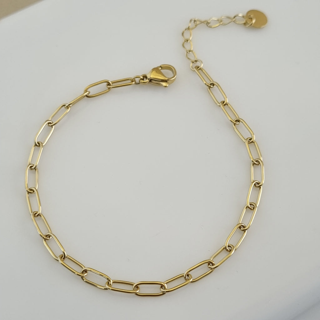 Treshire 18K gold plated Aura Link bracelet with elongated rectangular links displayed on a white marble surface.
