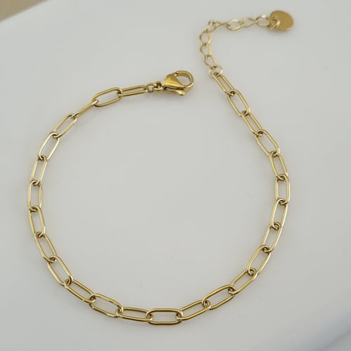 Treshire 18K gold plated Aura Link bracelet with elongated rectangular links displayed on a white marble surface.