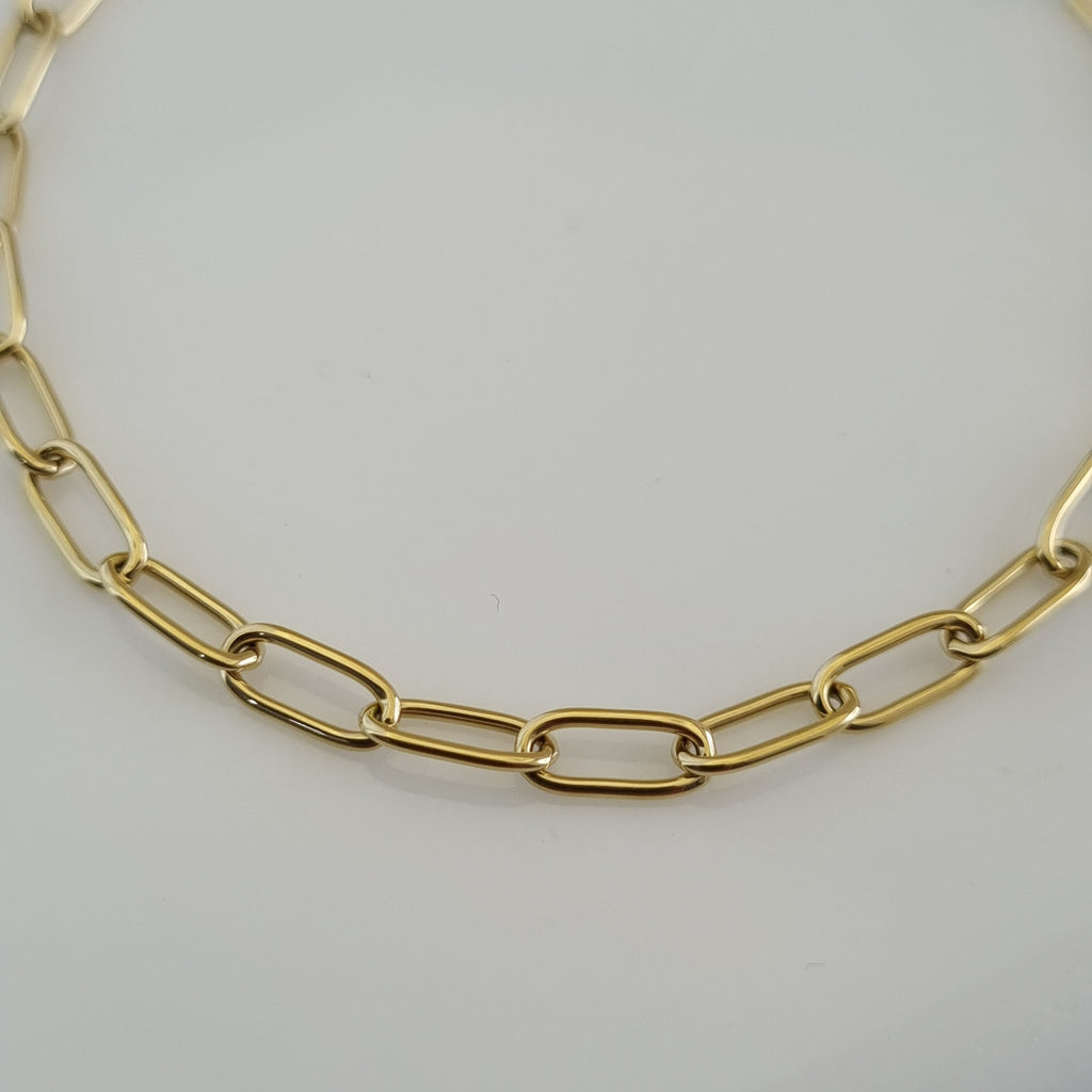 Treshire 18K gold plated Aura Link bracelet with elongated rectangular links displayed on a white marble surface.