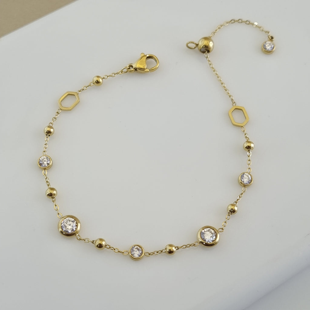 Treshire 18K gold plated adjustable bracelet featuring gold beads, hexagonal links, and bezel-set crystals on a fine gold chain.