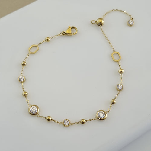 Treshire 18K gold plated adjustable bracelet featuring gold beads, hexagonal links, and bezel-set crystals on a fine gold chain.