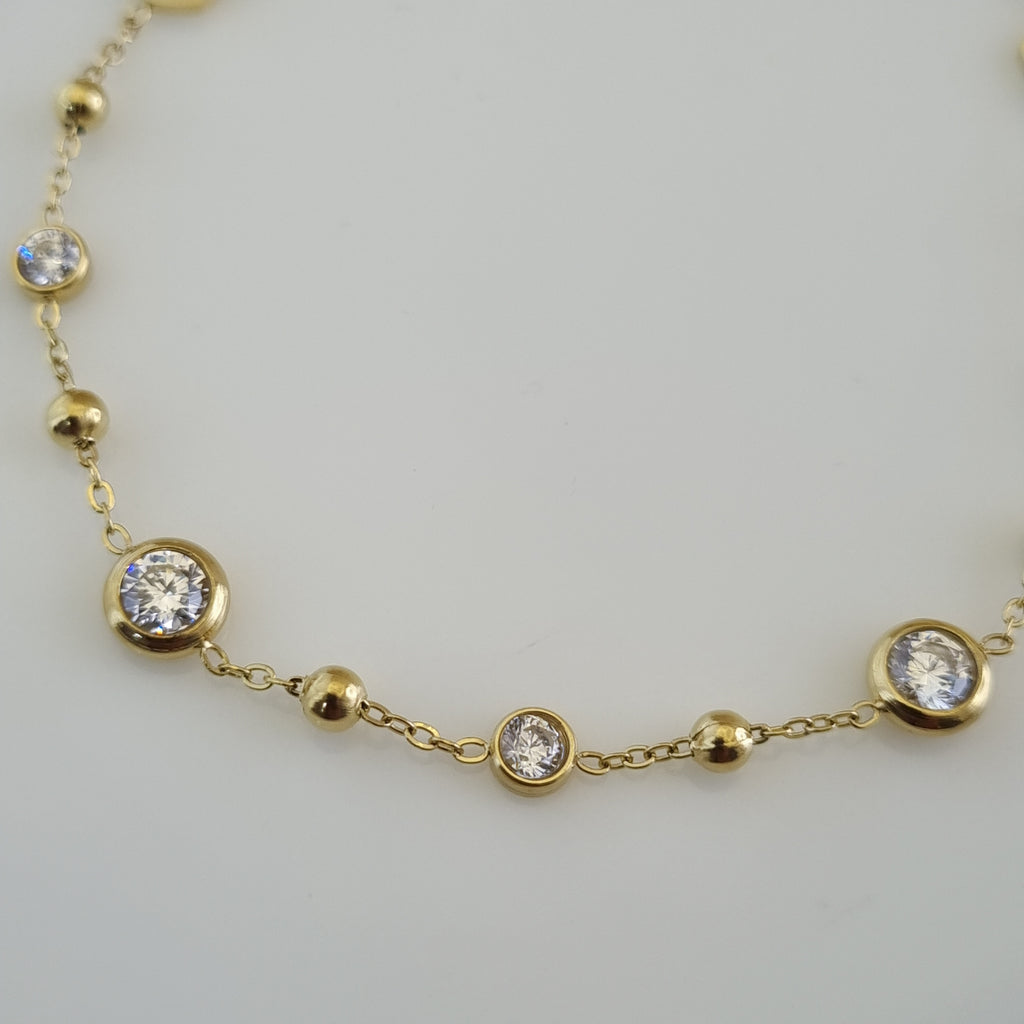 Treshire 18K gold plated adjustable bracelet featuring gold beads, hexagonal links, and bezel-set crystals on a fine gold chain.