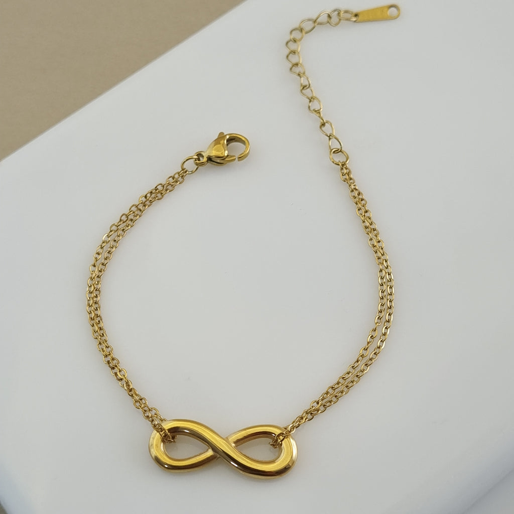 Treshire 18K gold plated Eternal Bond bracelet featuring an infinity symbol on a double-strand gold chain, displayed on a white surface.
