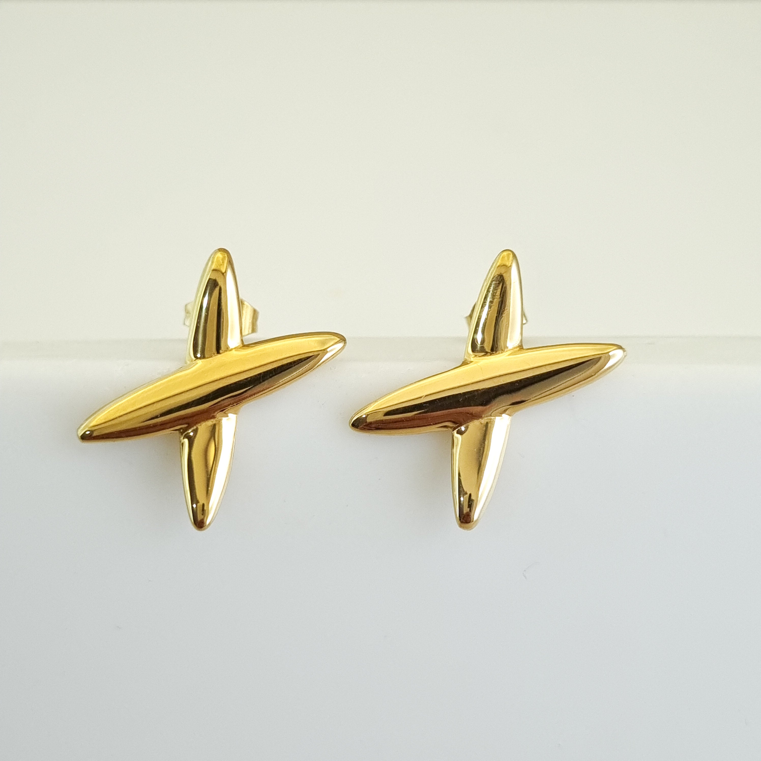 18K gold-plated star earrings, waterproof gold studs, anti-tarnish cross earrings, hypoallergenic celestial jewelry, sculptural gold studs, architectural star earrings.