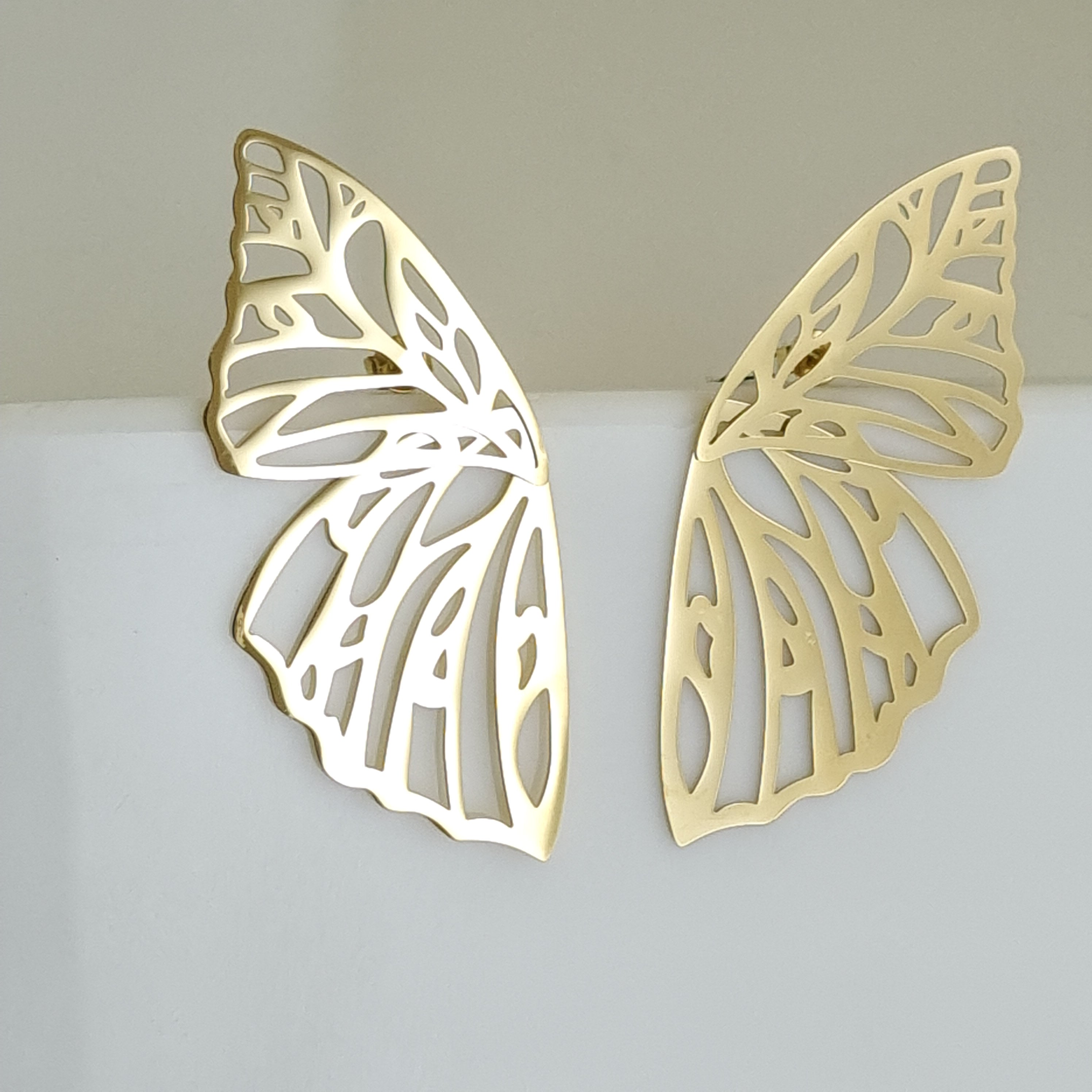 18K gold-plated wing earrings, waterproof gold studs, anti-tarnish butterfly jewelry, hypoallergenic statement earrings, filigree gold jewelry, architectural wing earrings.