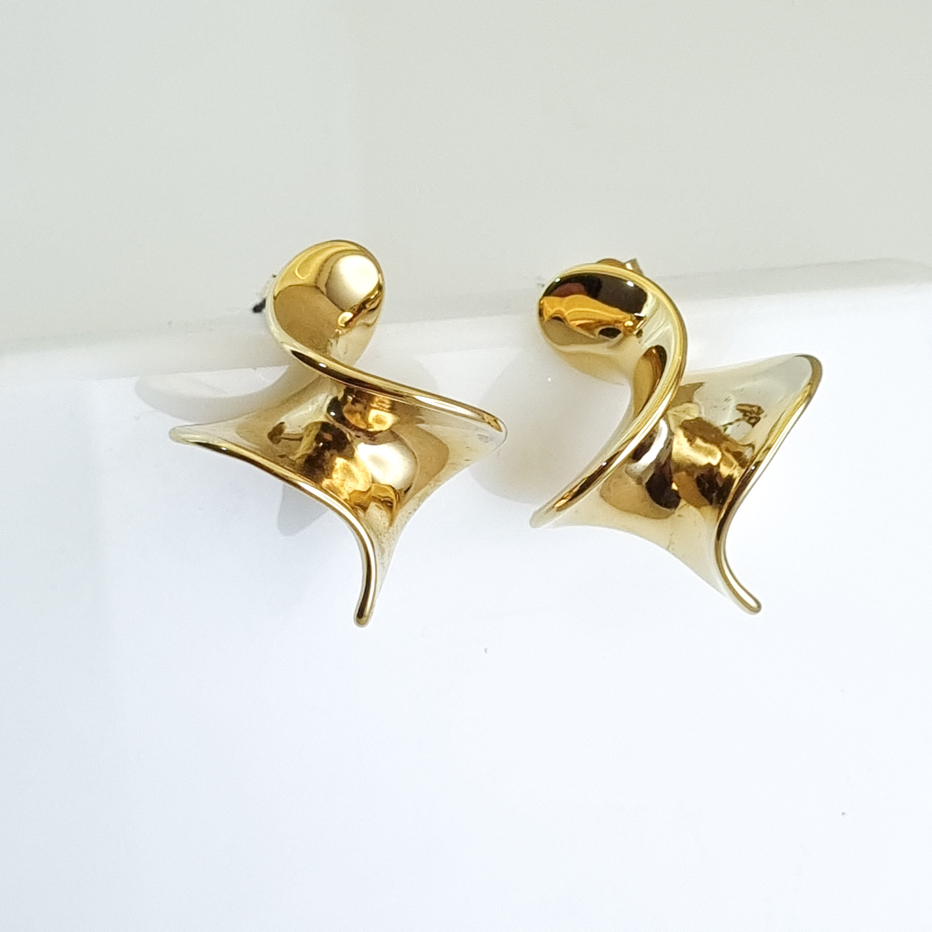 18K gold-plated twist hoops, waterproof gold earrings, anti-tarnish statement hoops, hypoallergenic luxury jewelry, sculptural gold earrings, fluid twist hoop earrings.