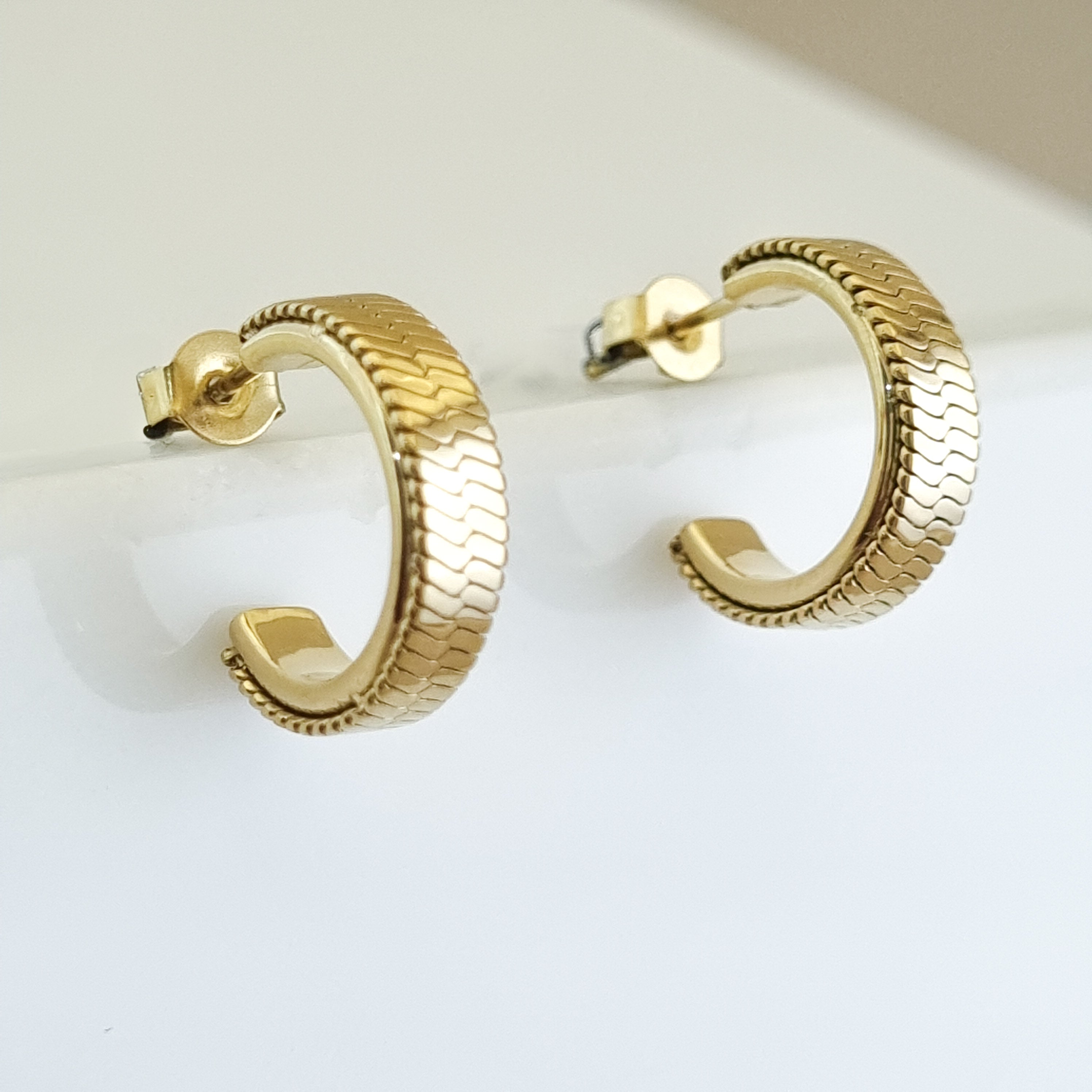 18K gold-plated textured hoops, waterproof gold earrings, anti-tarnish patterned huggies, hypoallergenic luxury jewelry, sculptural gold hoops, chevron embossed earrings.