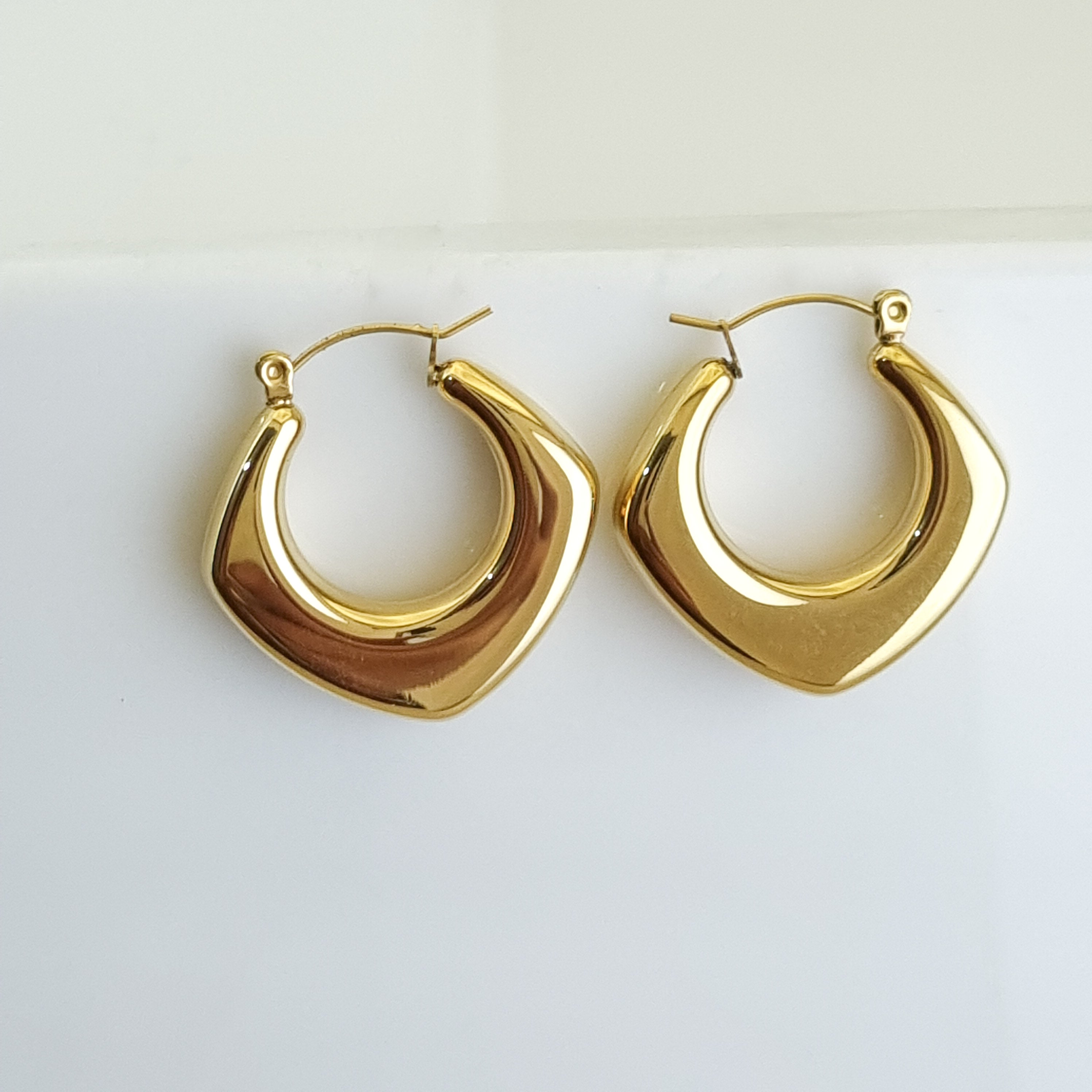 18K gold-plated crescent hoops, waterproof gold earrings, anti-tarnish statement hoops, hypoallergenic luxury jewelry, sculptural gold earrings, tapered hoop earrings.